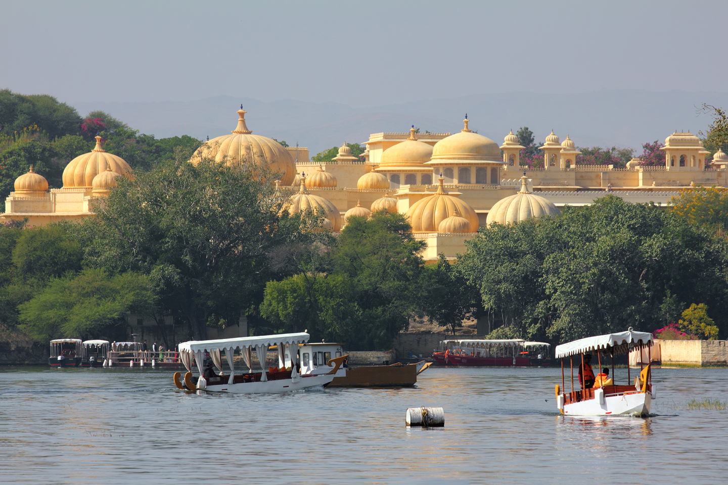Boats and palace on Pichola lake in Udaipur